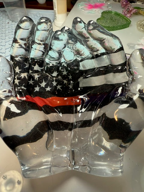 Hands cradling the Fire/Law Enforcement flag