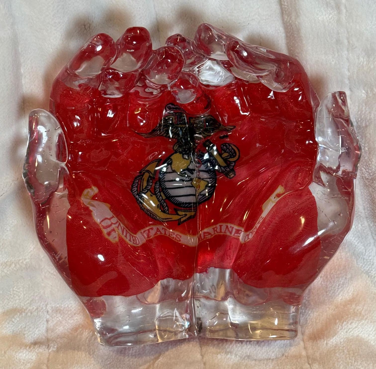 Hands cradling the U.S. Marine Corps flag